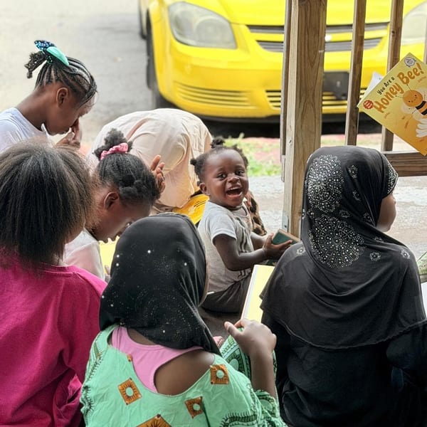 Children gathered together smiling outdoors