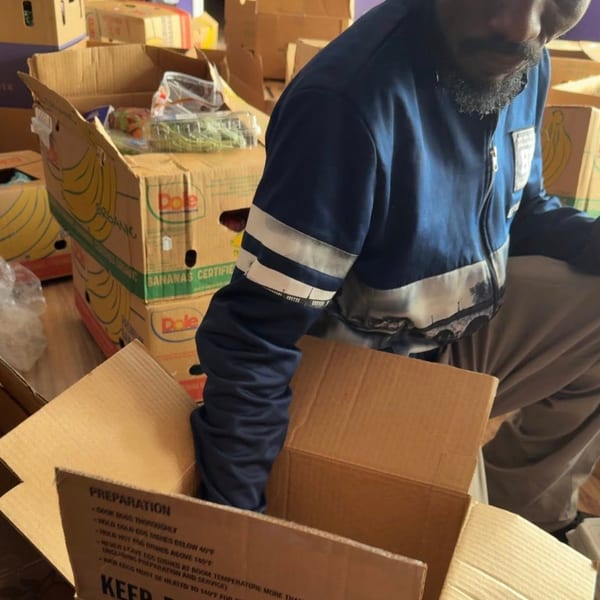 Volunteer organizing refrigerated shipment boxes