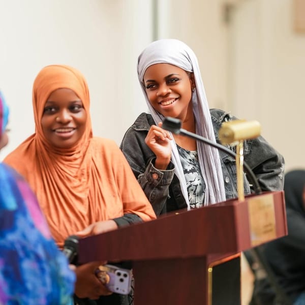 Women speaking at a community podium