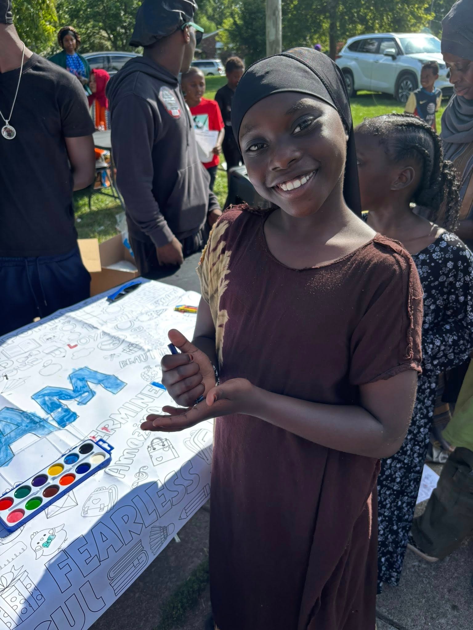 Girl coloring at an outdoor community event