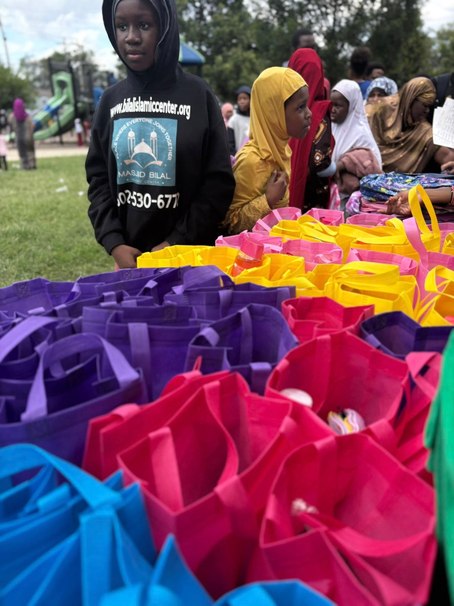 Community gathering with colorful gift bags