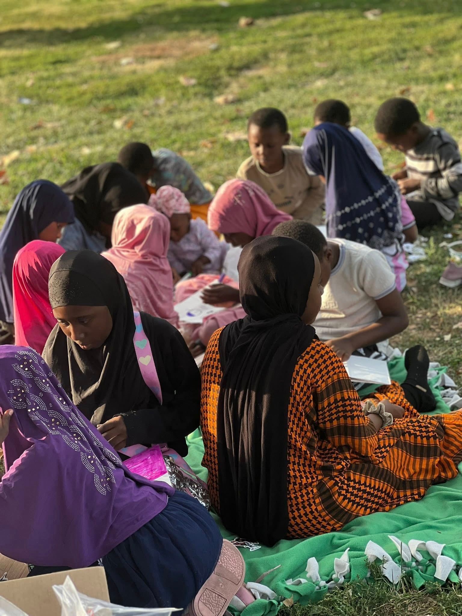 Community gathering outdoors on a hillside