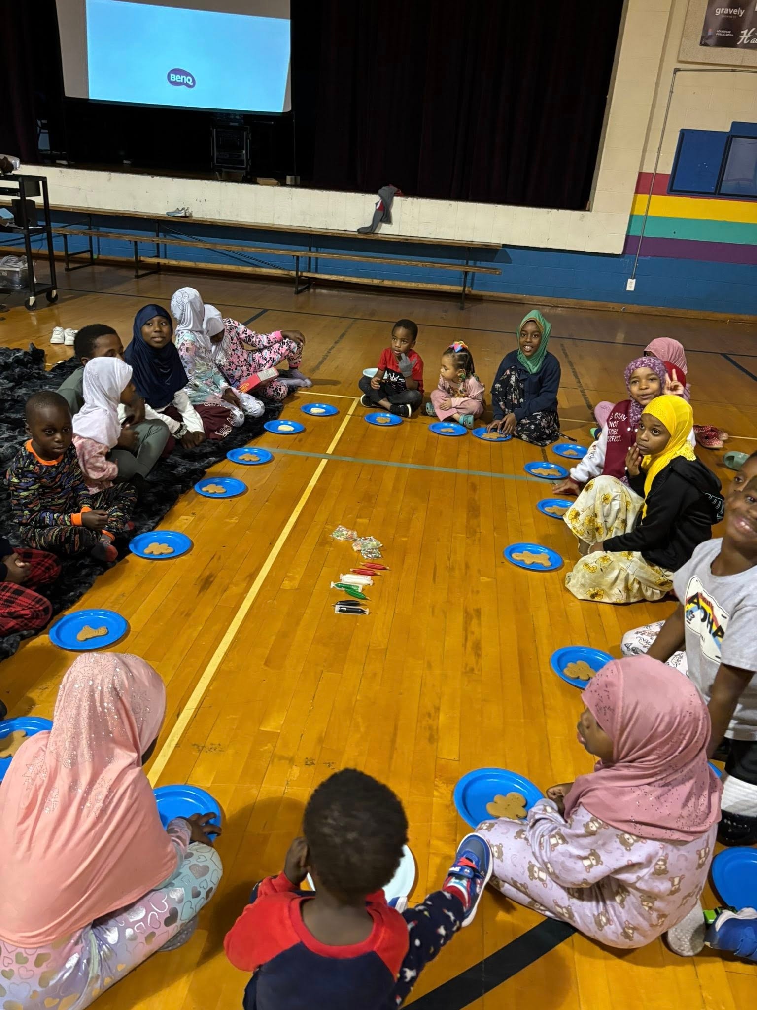 Children sitting in a circle and sharing snacks