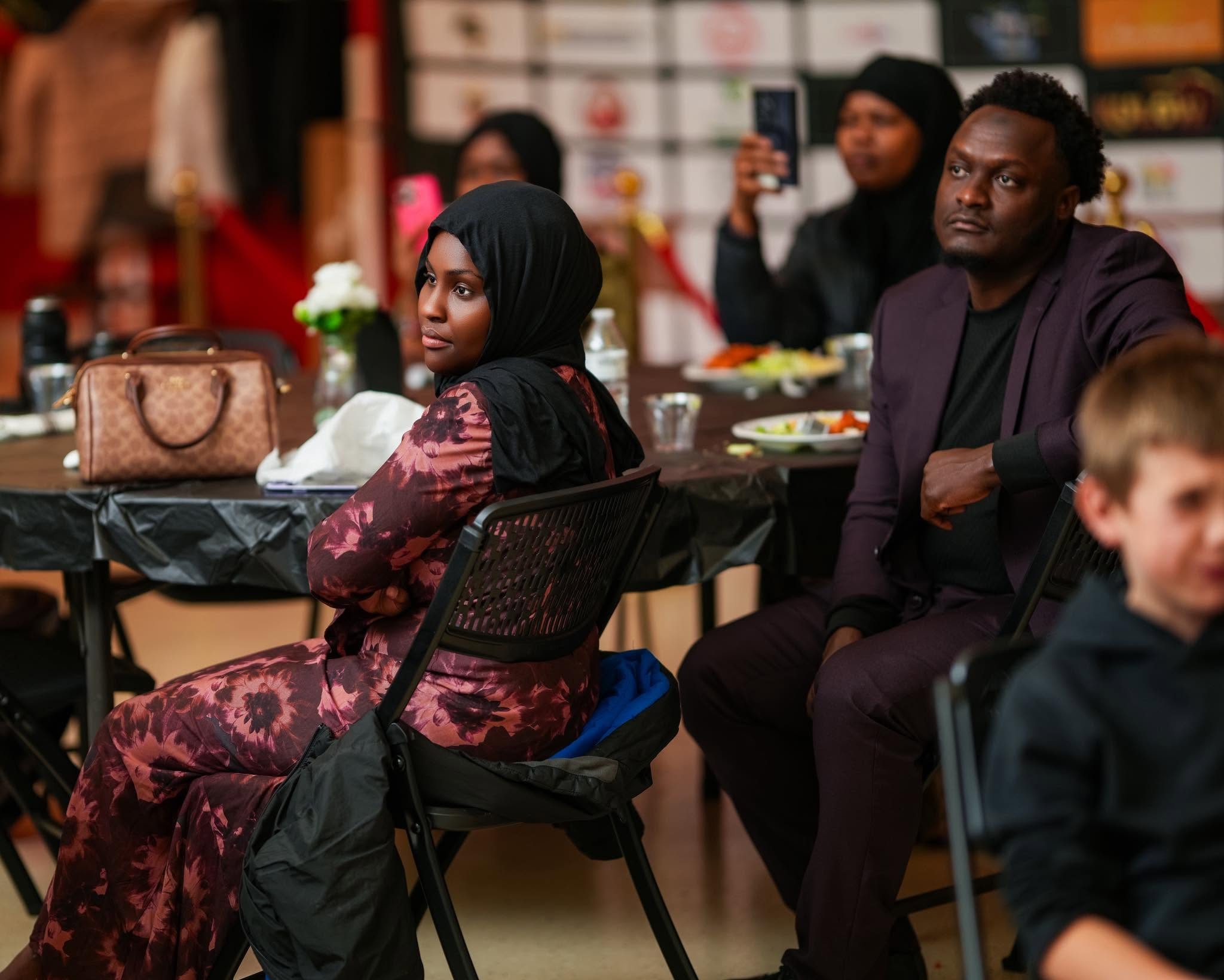 People attending a formal community dinner