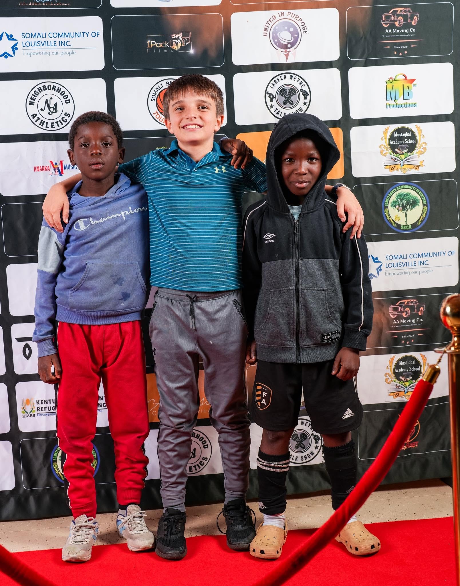 Three young athletes posing at an event