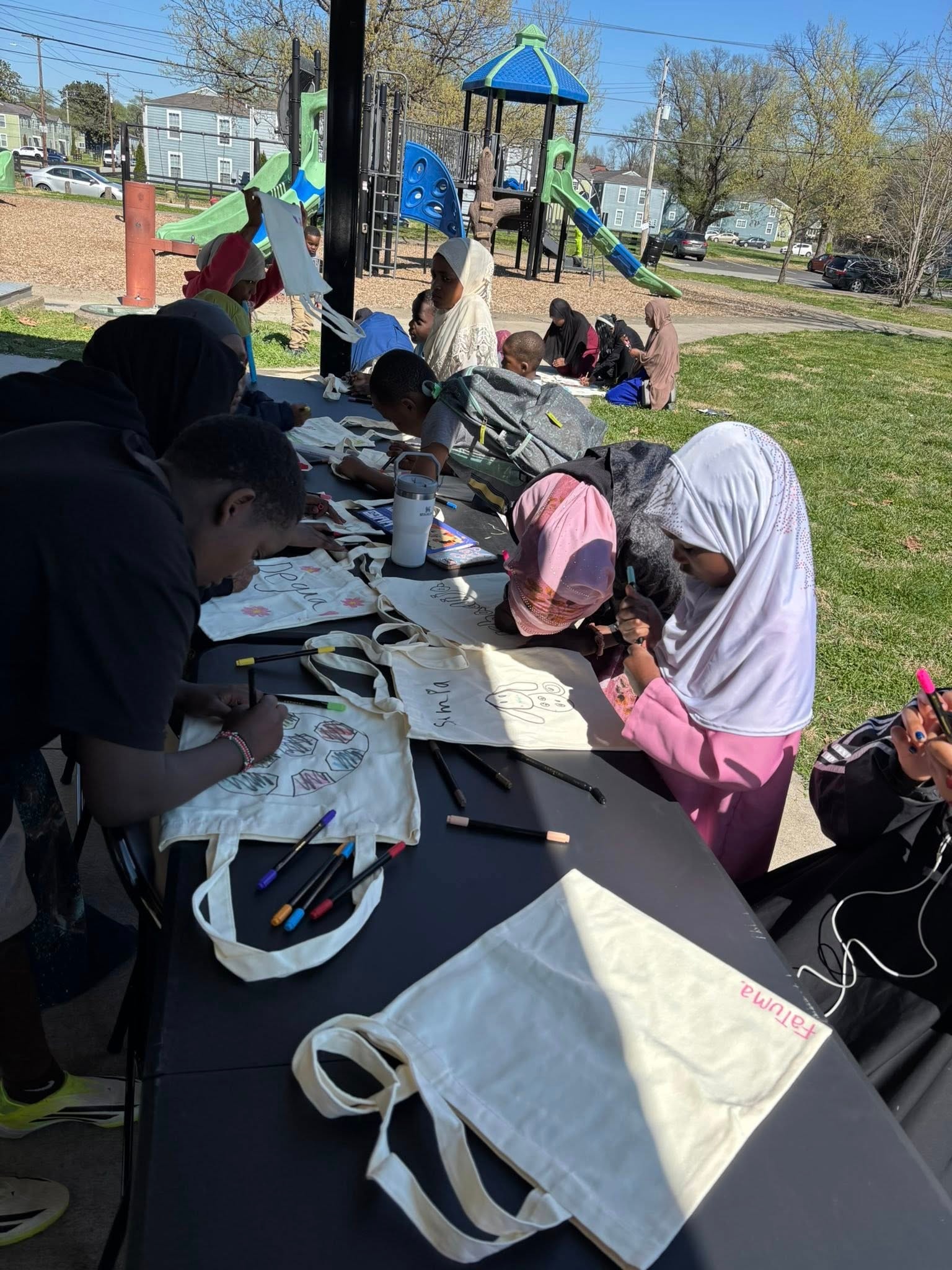 Children drawing at a community park event