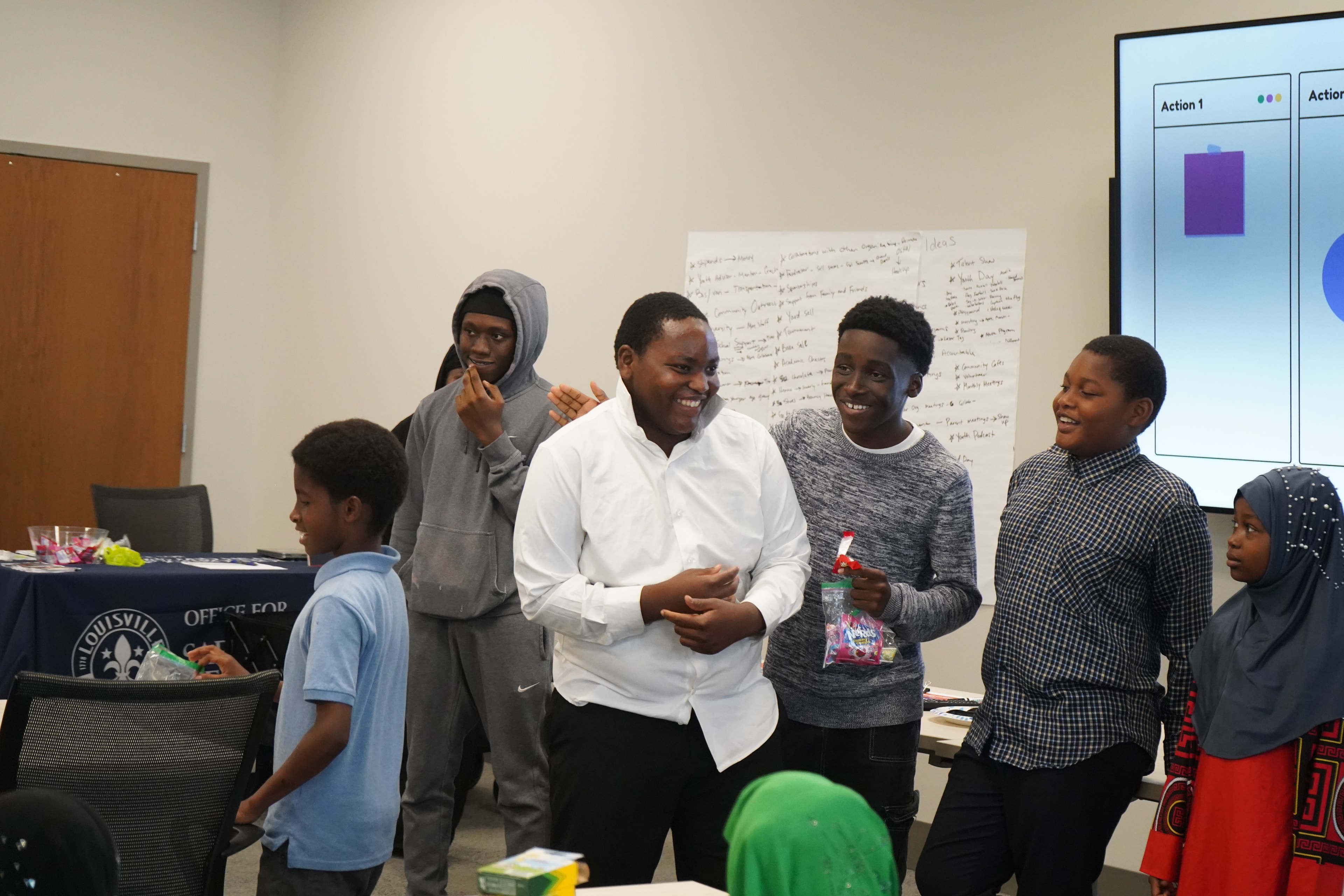 Group of young people laughing together indoors