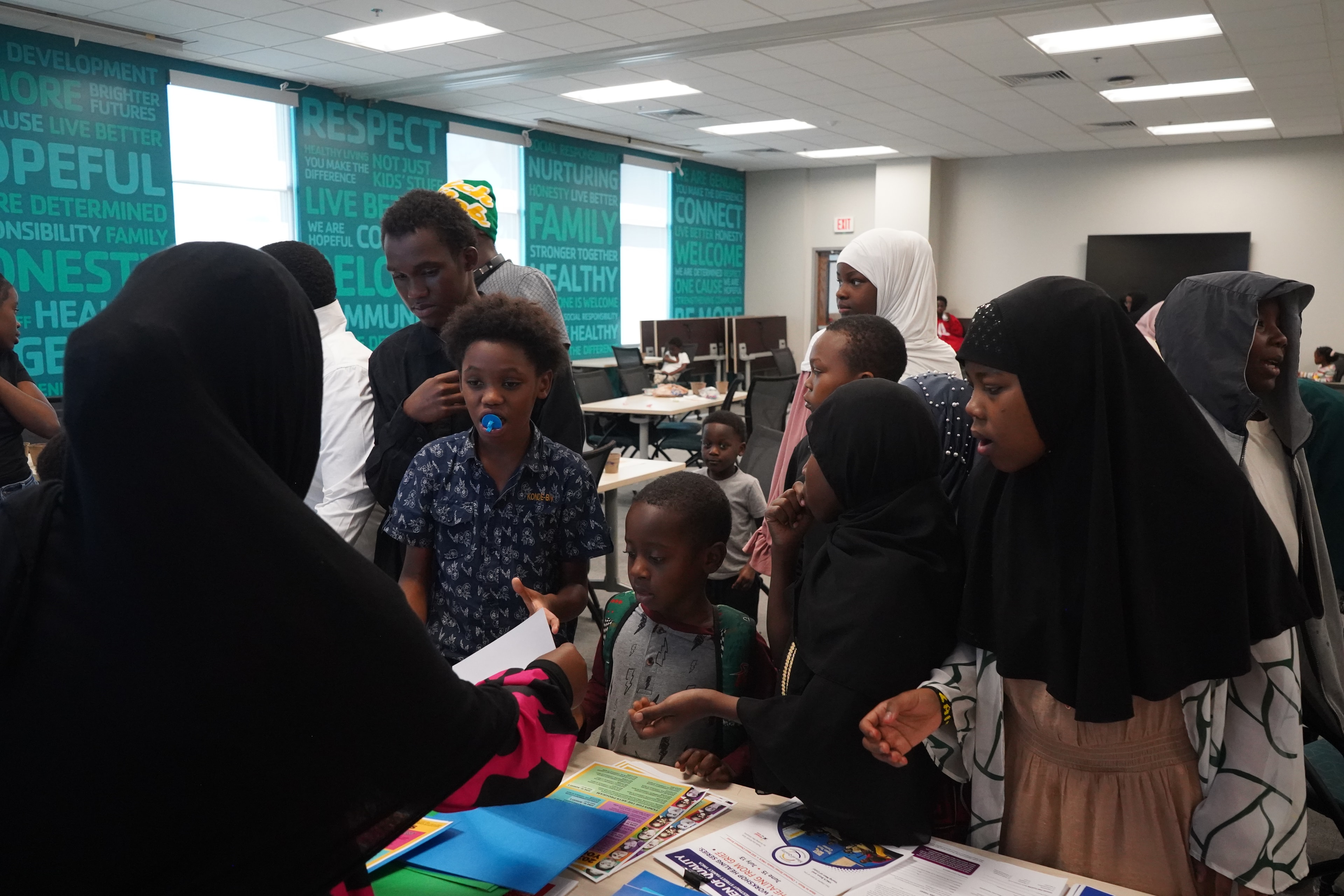 Children learning with adults at a community center