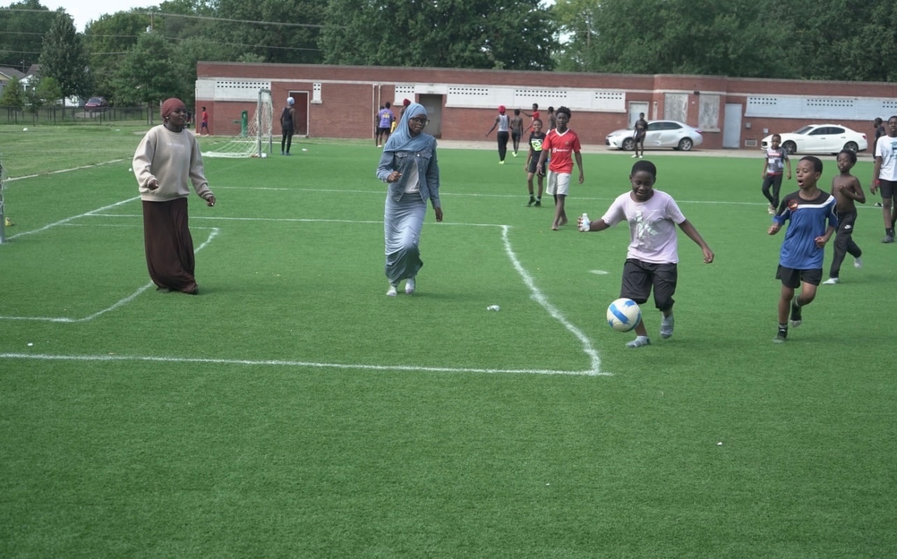 Children playing soccer on a school field