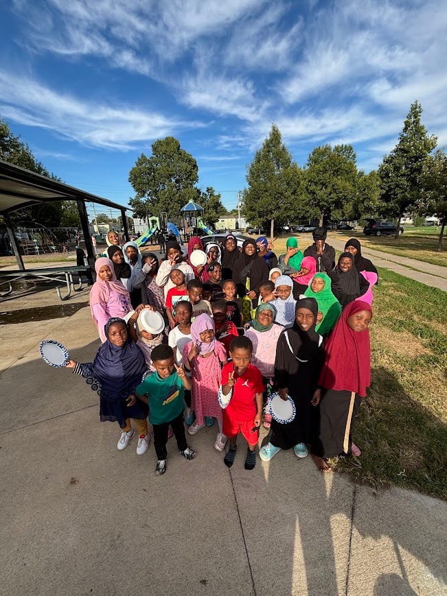 Large group of children gathered at a park playground